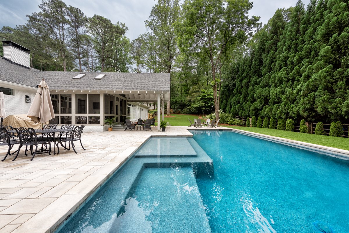 Rectangular pool with sun ledge beside a screened porch, Atlanta GA