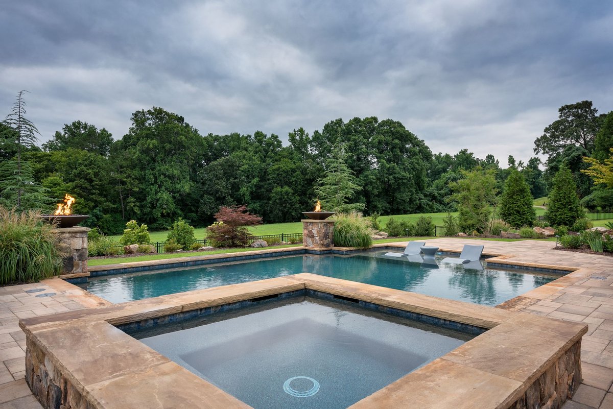 Pool and raised spa with twin stone fire bowls overlooking the golf course, Traditions of Braselton, Jefferson GA