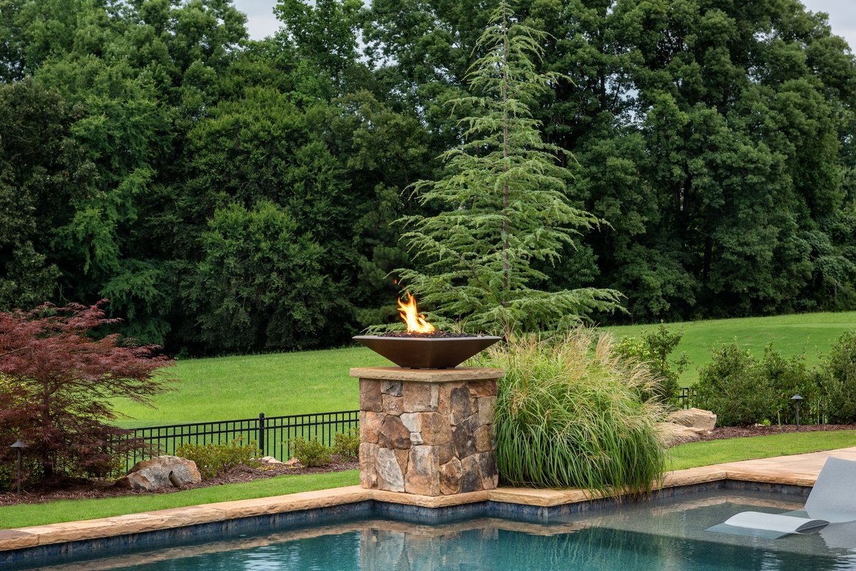 Stone-clad pedestal fire bowl at the pool's edge, Traditions of Braselton, Jefferson GA